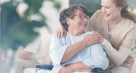Older lady being visited by a nurse at home