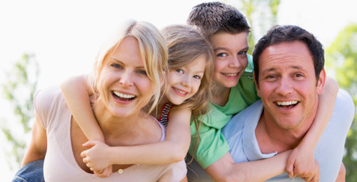 Smiling parents with two children
